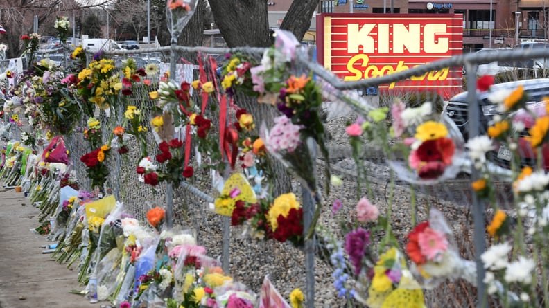 BOULDER, CO -MARCH 23: Hundreds of flowers have een placed into the fence surrounding the King Soopers on Table Mesa Drive on March 23, 2021 in Boulder, Colorado. Hundreds of people turned out late in the day to pay their respects to those that lost their