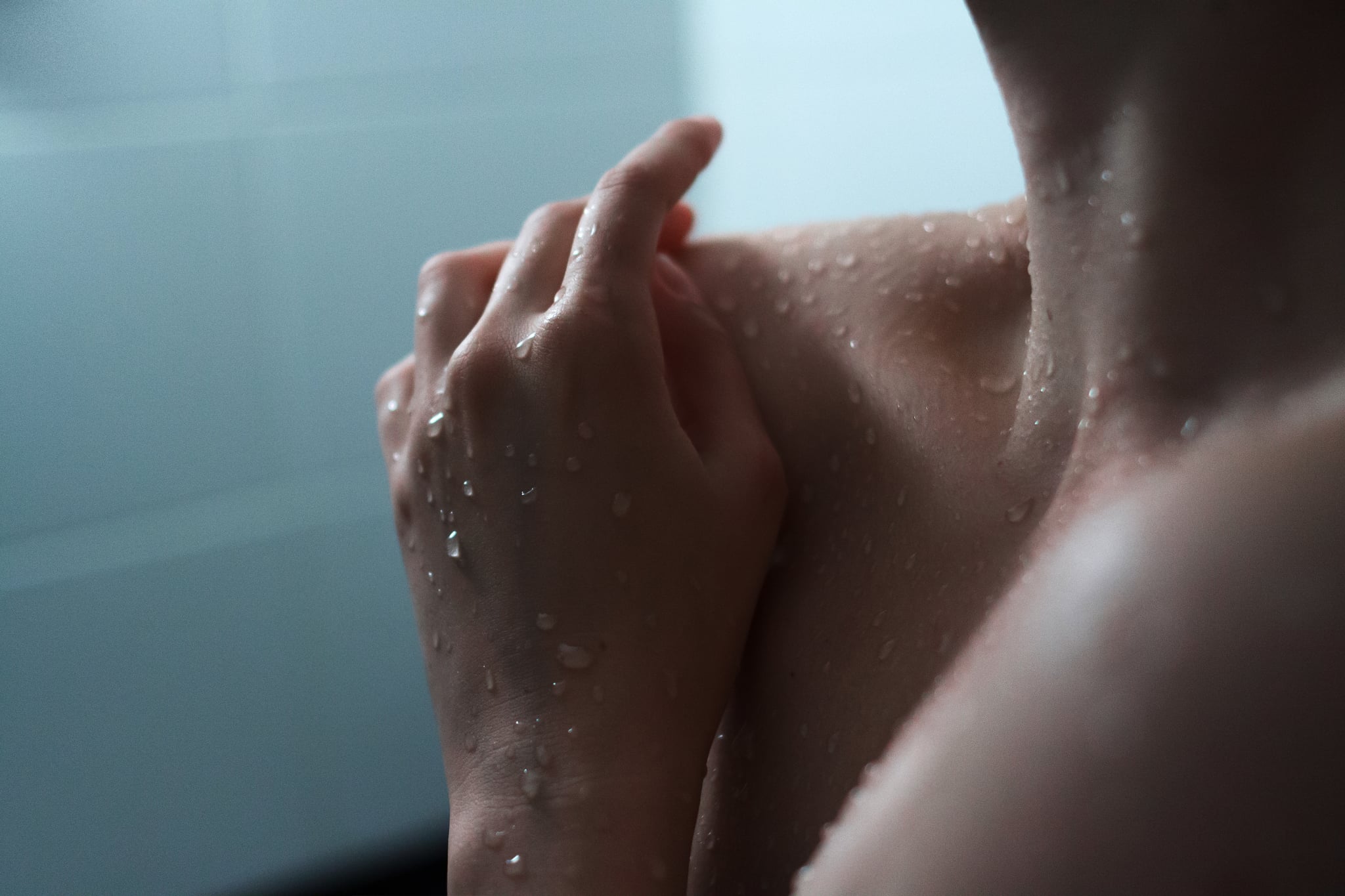Portrait of young Caucasian woman enjoying a shower.