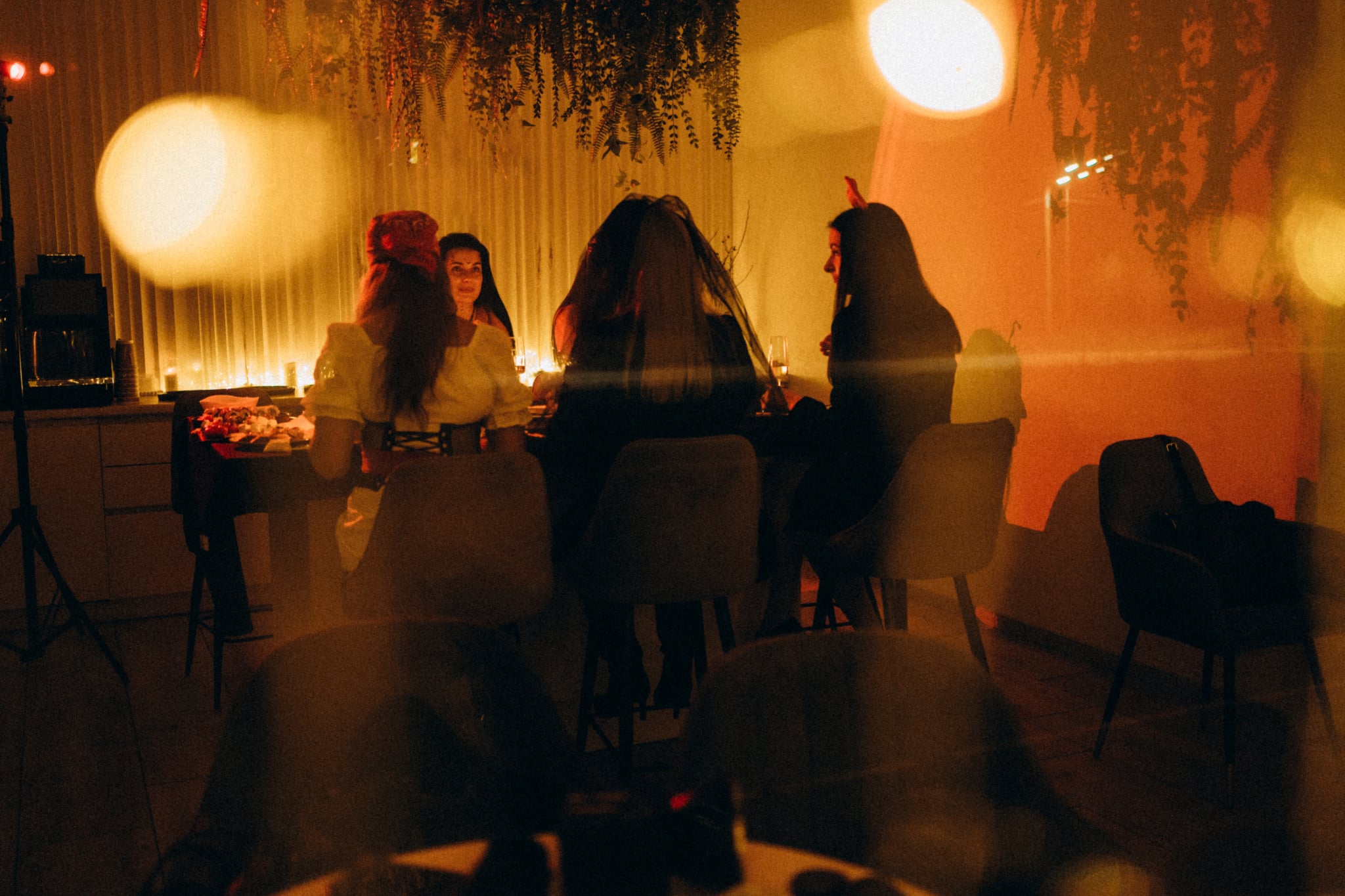 Group of women gathering at a party, enjoying conversation and festive costumes