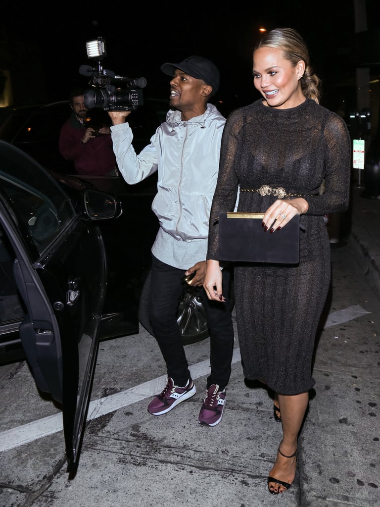 Chrissy wore strappy black sandals.
