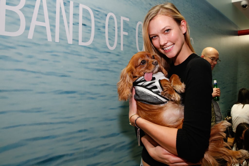 Karlie Kloss cuddled up to an adorable dog at the opening of the Band of Outsiders store in NYC's SoHo district on Tuesday.