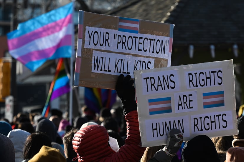 EDMONTON, CANADA - FEBRUARY 03, 2024:Activists hold placards as hundreds of activists, allies, and members of the transgender community gather at Dr. Wilbert McIntyre Park in Old Strathcona, protesting Premier Danielle Smith's proposed LGBTQ2S+ legislatio