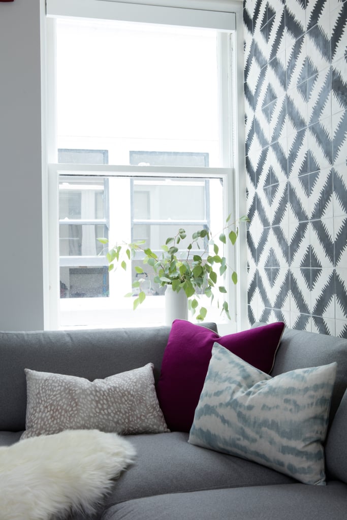 The backsplash is repeated on an accent wall on the opposite side of the kitchen-slash-break room. The comfy sectional is a great place for casual meetings and brainstorming sessions.