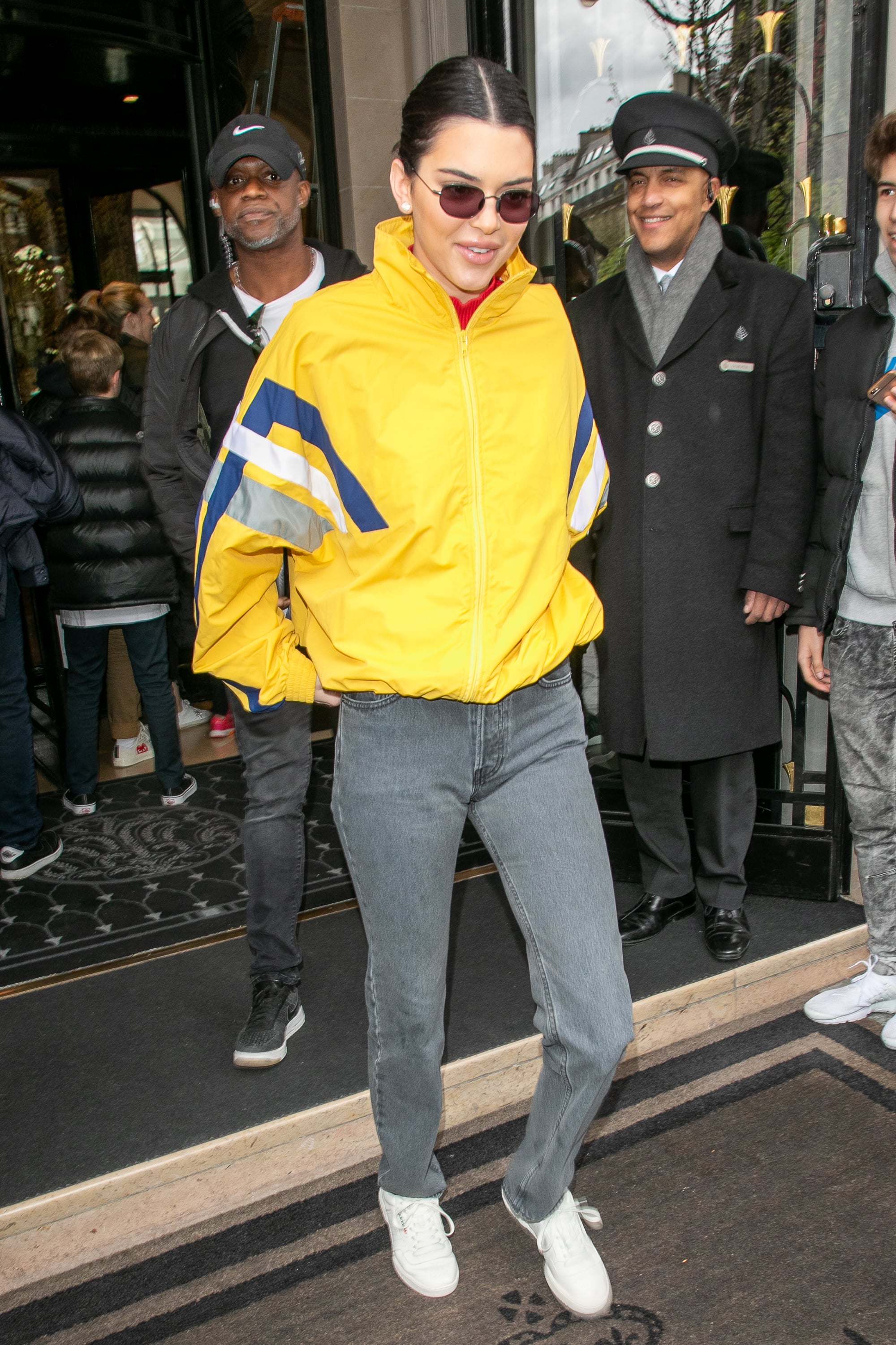 Kendall's yellow Balenciaga jacket popped on the streets of Paris. She wore it with grey Yeezy jeans and white Adidas low-tops.