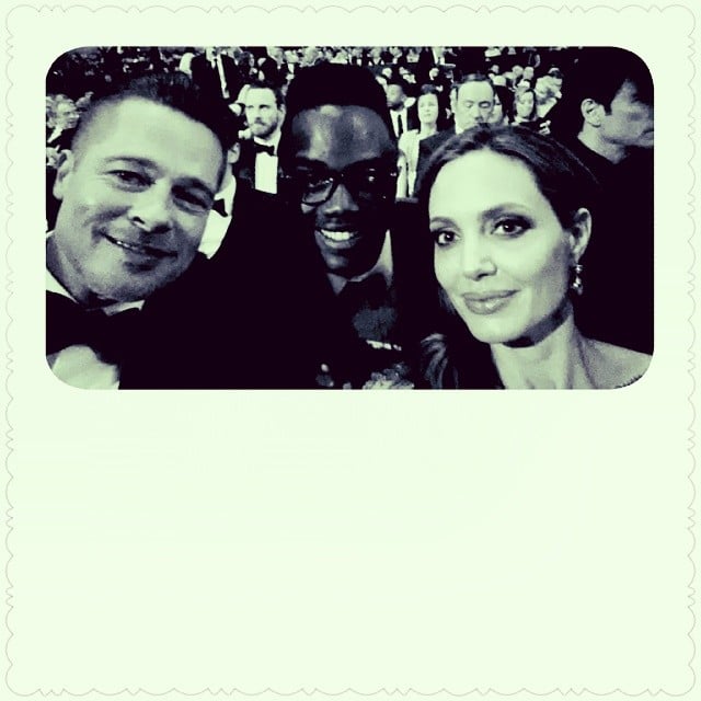 Brad Pitt and Angelina Jolie leaned in for a picture with Lupita's brother.
Source: Instagram user nyongolaflame