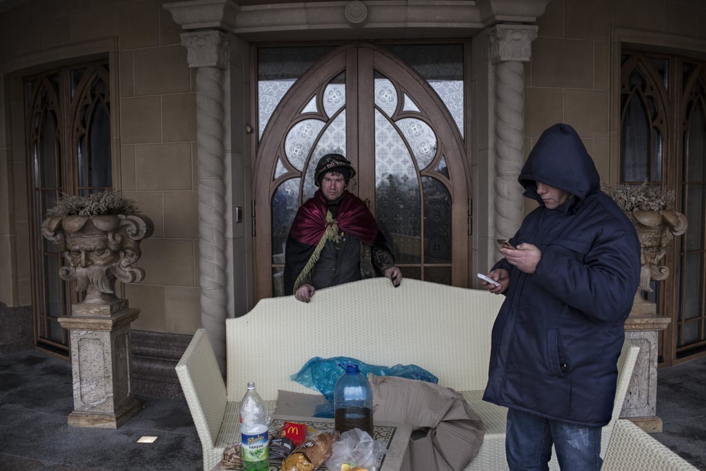 Antigovernment protesters stood guard outside the mansion's entrance.