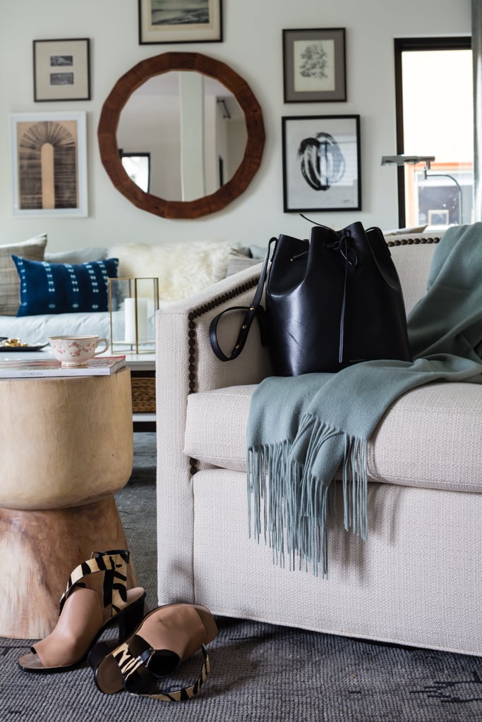 Decide how the space will be used: Erica and her husband, Abe, love entertaining friends, but also wanted the living room to serve as a play space for their son, Quincy. The solution? Lots of seating options and stylish storage.
Choose black and white art: For gallery wall newbies, Alex recommends starting with black and white artwork. It's easier to combine vintage and contemporary photos and paintings for a sophisticated look.