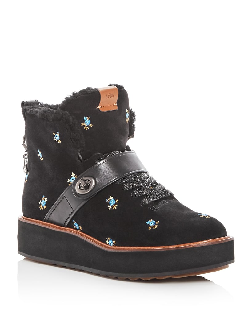 These Coach Urban Hiker Embroidered Suede and Shearling Platform Wedge Booties ($350) are part sneaker, part boot, and full perfection.