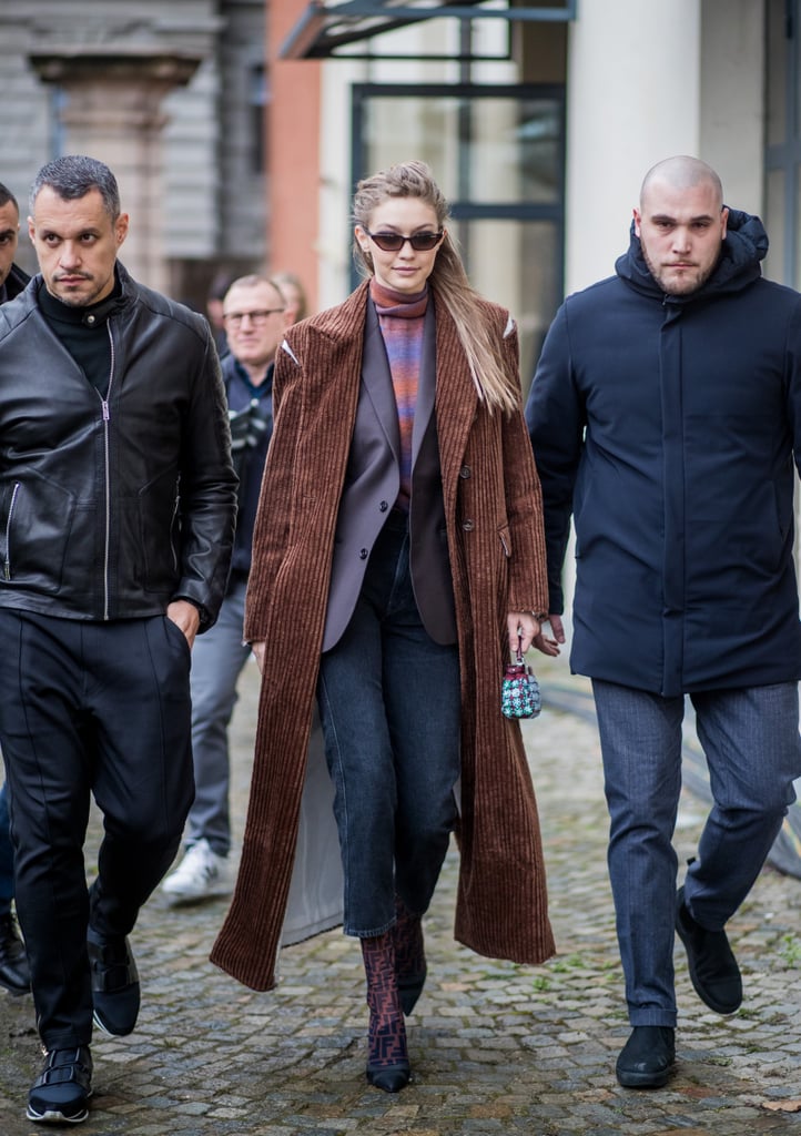 Gigi layered up in a brown corduroy split shoulder coat by Christian Dada.