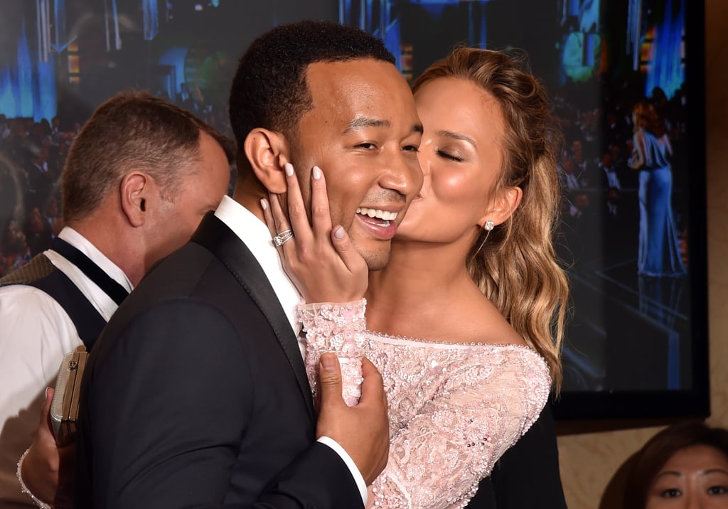Chrissy Teigen gave her husband, John Legend, a big kiss in the press room.