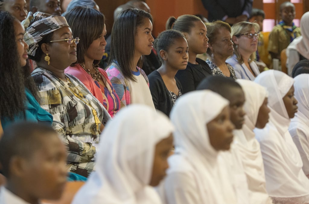 Michelle, Malia, and Sasha Obama attended a dance performance in Dar es Salaam, Tanzania, in July 2013.