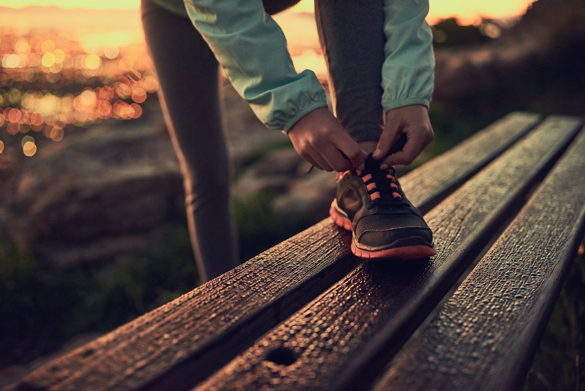 Shot of an unrecognisable woman tying her shoe laces before a run