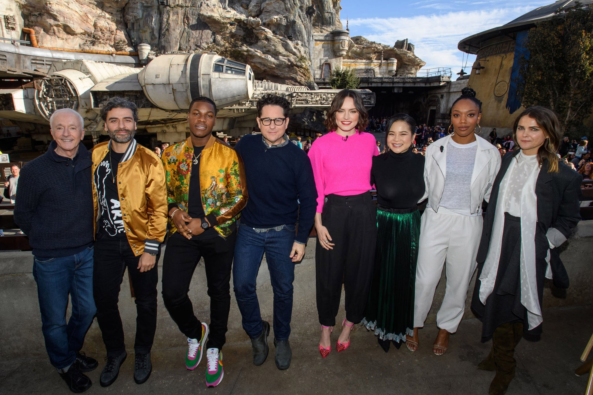 ANAHEIM, CA  DECEMBER 02:  In this handout photo provided by Disney Resort, the cast of the upcoming film, Star Wars: The Rise of Skywalker (L-R) Anthony Daniels, Oscar Isaac, John Boyega, director J.J. Abrams, Daisy Ridley, Kelly Marie Tran, Naomi Ackie and Keri Russell pose in front of the Millennium Falcon in Star Wars: Galaxys Edge at Disneyland Park in December 2, 2019 in Anaheim, California, while promoting  Star Wars: The Rise of Skywalker, in theatres December 20. (Photo by Richard Harbaugh/Disneyland Resort via Getty Images)