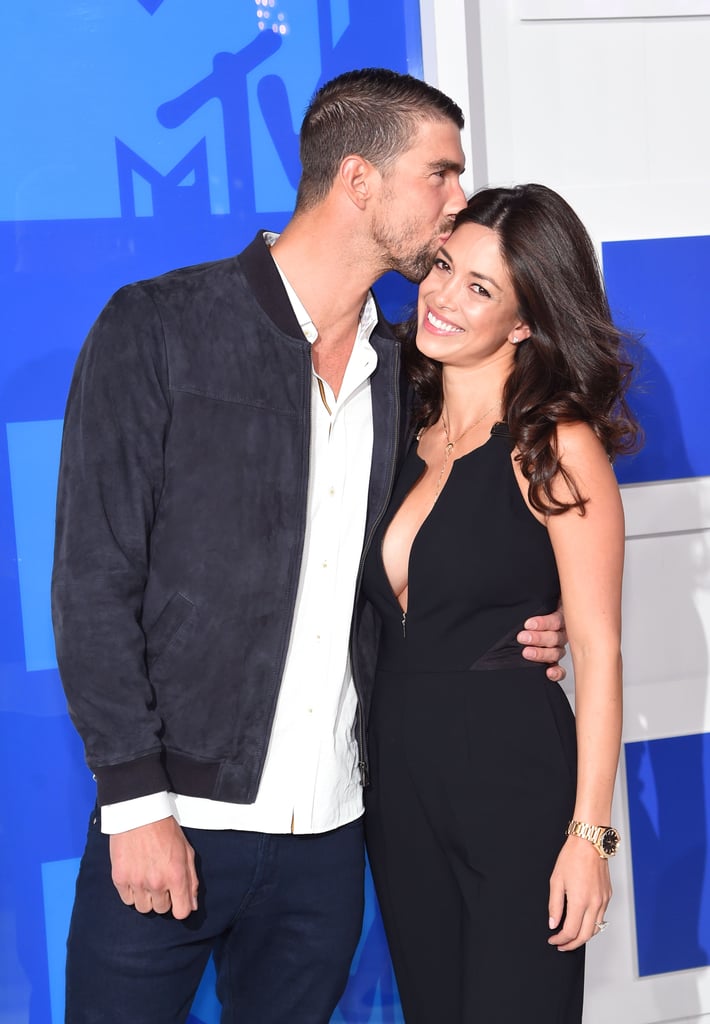 Michael Phelps and Nicole Johnson looked more in love than ever while walking the red carpet at the MTV Video Music Awards in NYC on Sunday. The pair was easily one of the cutest celebrity couples to roll up to the VMAs this year, sneaking in a few kisses in between fits of giggles in front of photographers. Nicole and Michael, who have been engaged since February 2015, left their adorable baby, Boomer, at home to enjoy the VMAs together. Nicole rocked a low-cut Ted Baker London jumpsuit and Michael wore a simple white shirt and jeans by the same designer. After presenting an award, Michael also spent time with Ansel Elgort, Chance the Rapper, and Jaden Smith. The gold medal winner wasn't the only Olympian strutting his stuff at Madison Square Garden, either — the Final Five (minus one!) also hit the red carpet in style.

    Related:

            
            
                                    
                            

            Michael Phelps Has the Best Reaction to Jimmy Fallon&apos;s Hilarious Ryan Lochte Impersonation