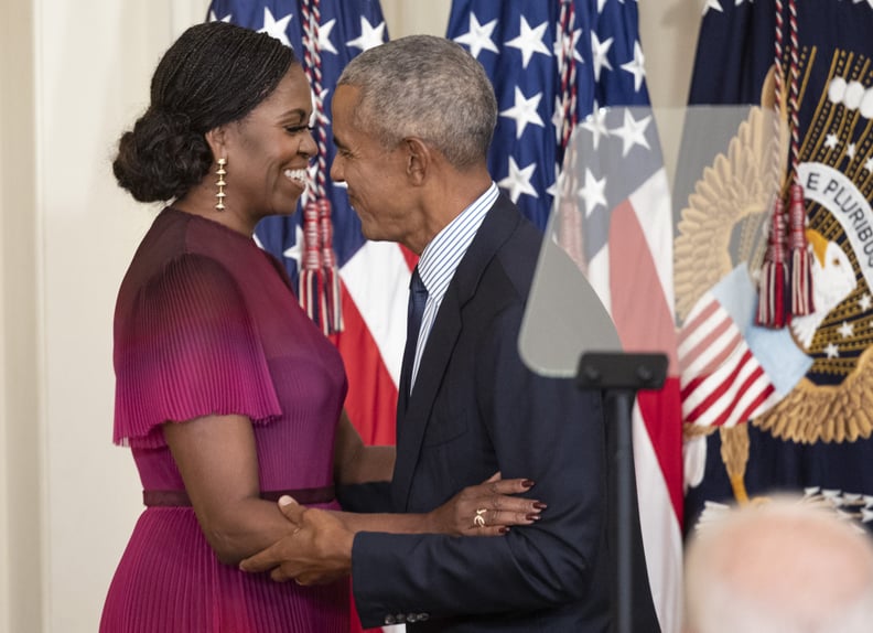 WASHINGTON, DC - SEPTEMBER 07: Former First Lady Michelle Obama and former U.S. President Barack Obama embrace at a ceremony to unveil their official White House portraits at the White House on September 7, 2022 in Washington, DC. The Obama's portraits wi