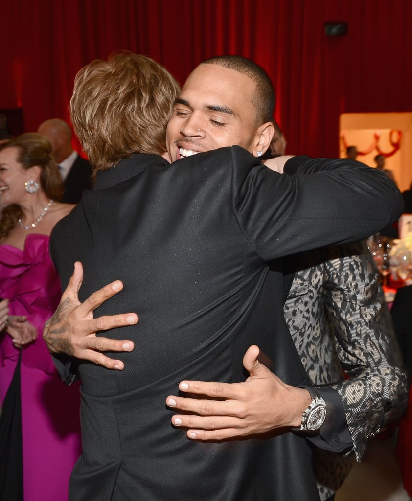 Chris Brown and Elton John shared a hug at his party.
Chris Brown and Elton John shared a hug at his party.