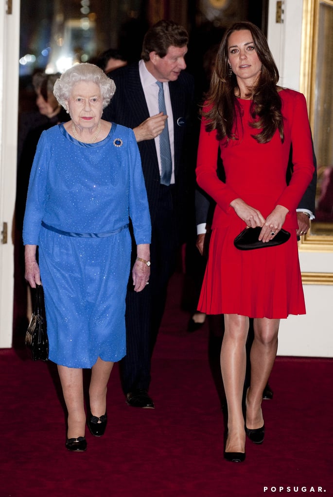 Kate Middleton held her own in a room full of A-listers when she joined Queen Elizabeth II in a special reception at Buckingham Palace on Monday for stars like Helen Mirren, Helena Bonham Carter, and many other British celebrities. The Duchess of Cambridge pulled another outfit repeat, donning the same red Alexander McQueen dress she wore to the queen's Diamond Jubilee celebration on June 3, 2012. This isn't the duchess's first time attending a royal event with her grandmother-in-law, but it is her first time playing her right-hand woman at an event at the palace. Last week, Kate's schedule was busy with two solo events, including a gala at the National Portrait Gallery on Tuesday and an art-therapy room opening at a high school in London on Valentine's Day. At the gala, Kate received a special treat, the queen's Nizam of Hyderabad Cartier necklace, to wear to the event, marking the start of the duchess's "royal makeover," which will reportedly involve more jewelry, more tiaras, and longer hemlines. 
While Kate has been grabbing headlines with her glamorous appearances, her husband, Prince William, and his brother, Prince Harry, have been experiencing a surprising bout of negative press over the past week. Critics have been calling the two royals hypocrites for campaigning against illegal hunting in Africa while partaking in hunting trips of their own. Meanwhile, Harry and William showed a rare display of annoyance when reporters spotted them helping with flood relief in Datchet, England, on Friday. William asked reporters to put down their cameras and help them with their work, only to be told by the royals' aides that they weren't allowed to pitch in due to lack of proper clothing. Harry also ruffled feathers when he told reporters that he was having fun with relief efforts until they showed up. Despite the negative press, William proved he was still the king of hearts on Sunday, when he made a dapper (albeit solo) appearance at the BAFTAs to present Helen Mirren with a special award.
