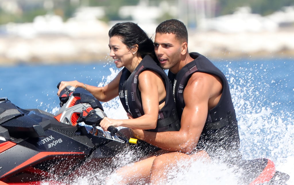 Kourtney Kardashian and boyfriend Younes Bendjima have been flaunting their love in and around Cannes for the better part of the week. On Wednesday, the reality star and her new man, a 23-year-old model, were spotted riding a jet ski and relaxing on a yacht in Antibes before a night out with friends at the Gotha nightclub. The following day, they were joined by Kourtney's sister Kendall Jenner and rapper A$AP Rocky for another day of lounging in barely there bikinis; the 38-year-old Keeping Up With the Kardashians star rocked a teeny-tiny pink two-piece, and we got a closer look at Younes's insane body as he showered on board. People reports that Younes is "fun for Kourtney," adding that he is "young, but very responsible." "He doesn't really party," the source adds. "He's very sweet to Kourtney."

    Related:

            
            
                                    
                            

            Try to Keep Up With Kourtney Kardashian&apos;s Hottest Bikini Moments
        
    
While Kourtney is living it up with her hot new guy, her ex-boyfriend Scott Disick is also making headlines for his escapades in the South of France. Scott, who shares three children with Kourtney, touched down in Cannes with actress Bella Thorne earlier in the week and was spotted showing some questionable PDA with the 19-year-old Disney Channel star at their Cannes resort. Keep reading to see photos of Younes and Kourtney's fun French adventures.

    Related:

            
            
                                    
                            

            20 Signs You&apos;re the Kourtney Kardashian of Your Friend Group