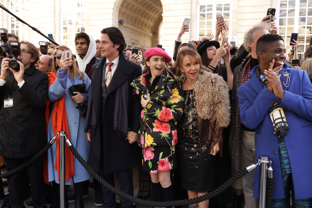 Wearing a floral coat with a pink beret.