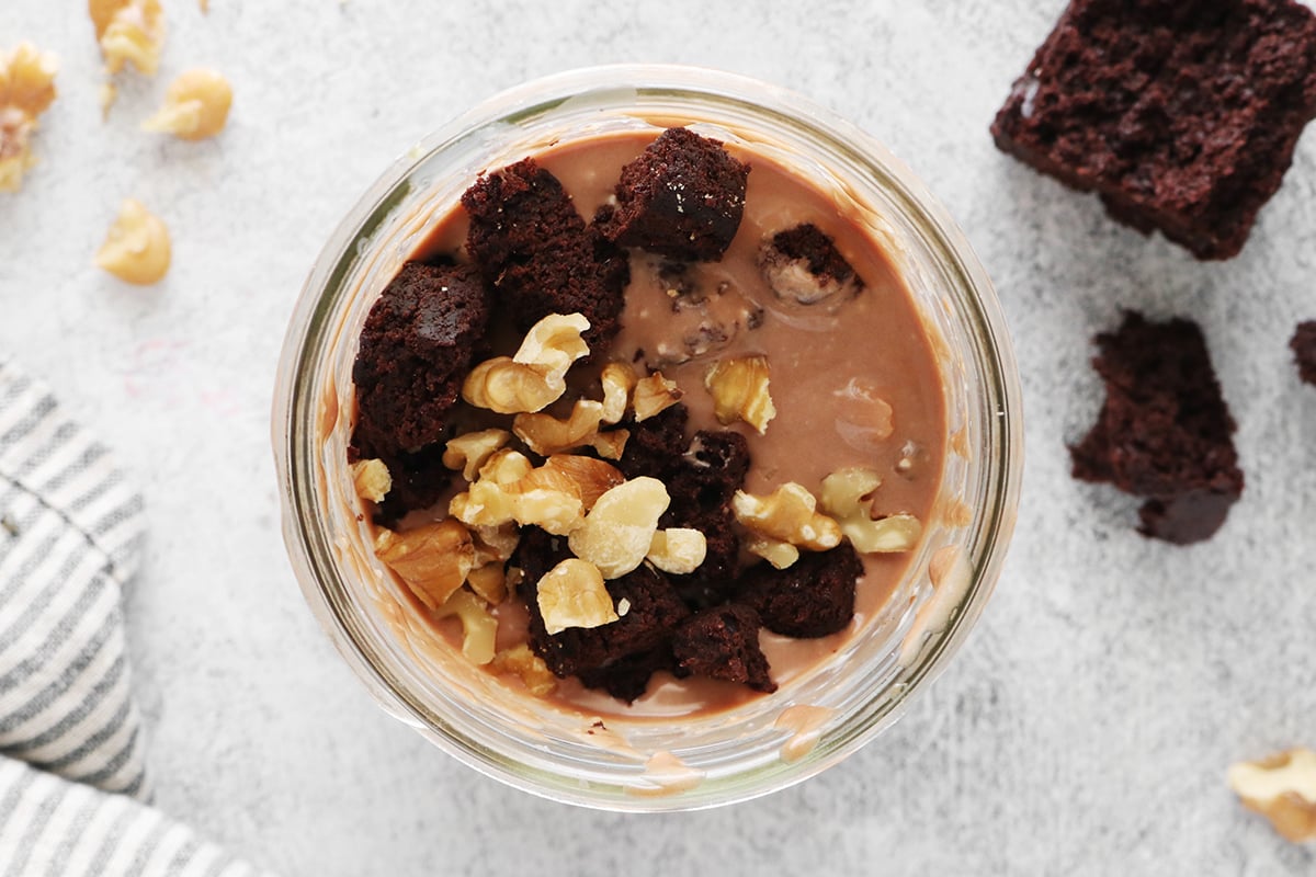 Brownie chunks and chopped walnuts in mason jar ice cream