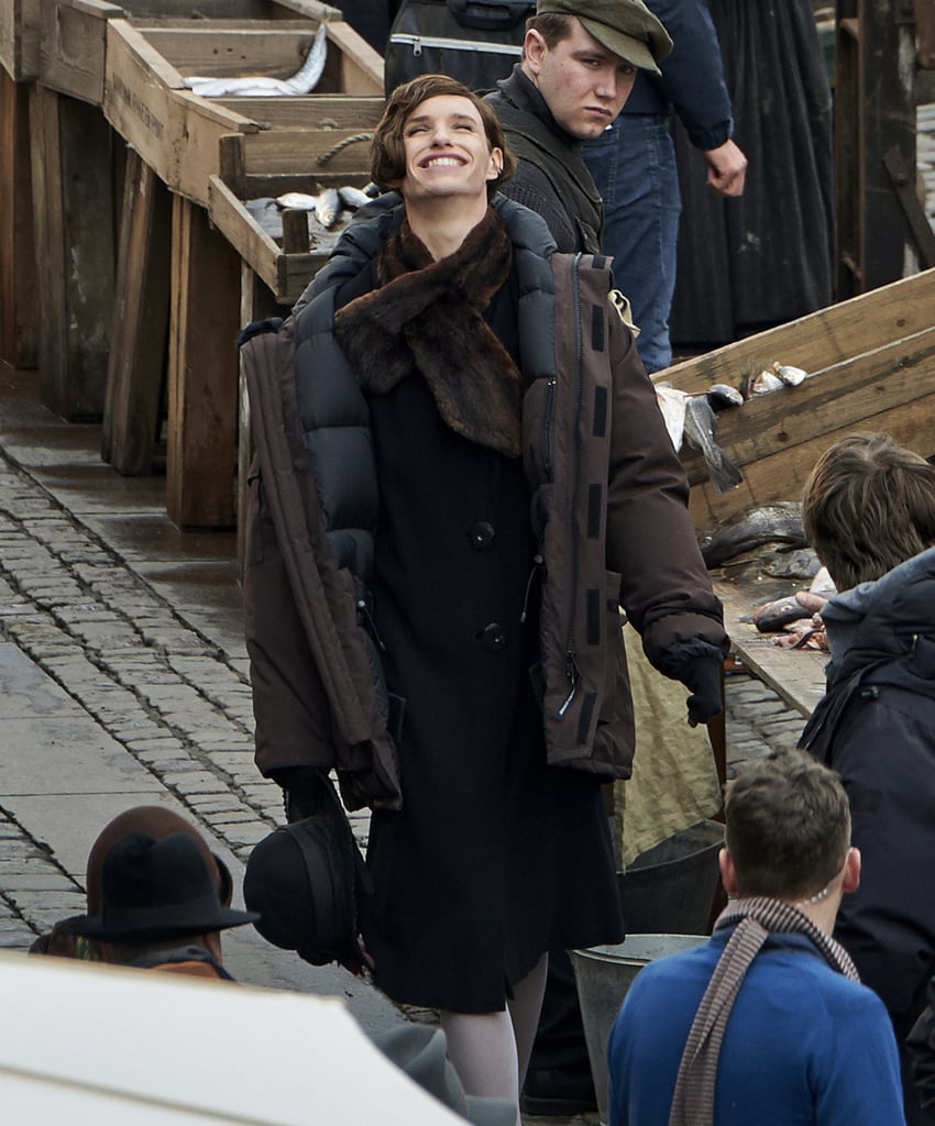 The actor smiled while walking around a fish market.
