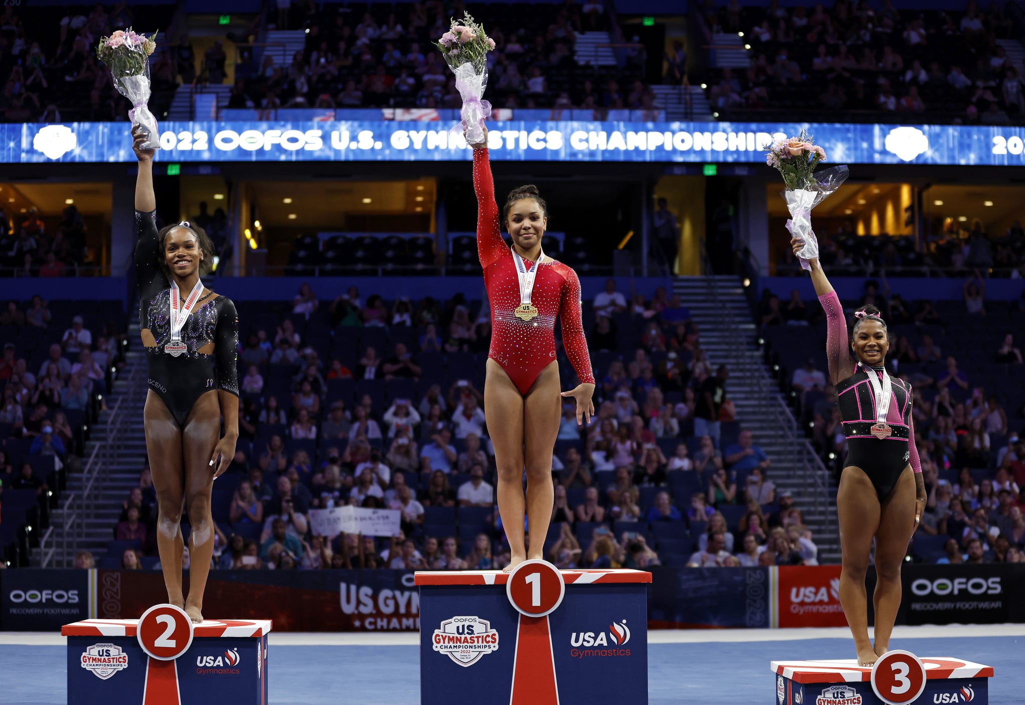 TAMPA, FLORIDA - AUGUST 21: Shilese Jones, Konnor McClain, and Jordan Chiles celebrate winning the all around competition during the 2022 US Gymnastics Championships at Amalie Arena on August 21, 2022 in Tampa, Florida. (Photo by Mike Ehrmann/Getty Images)