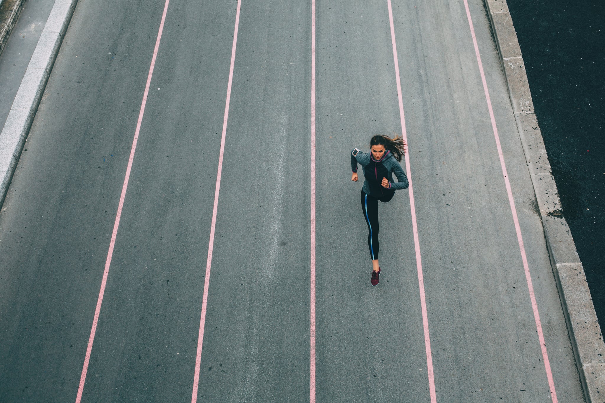 A woman running outside in the  city.