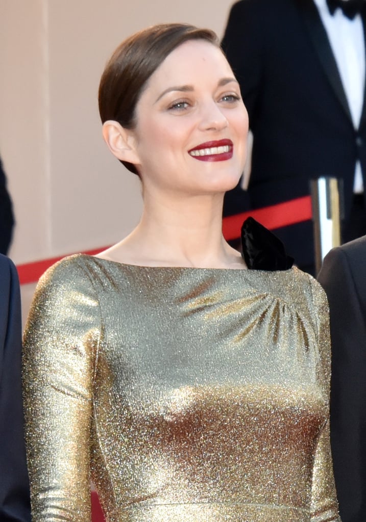 At the premiere of From the Land and the Moon, Marion Cotillard let her gleaming dress stand out, keeping her makeup pared down save for a crimson lip.