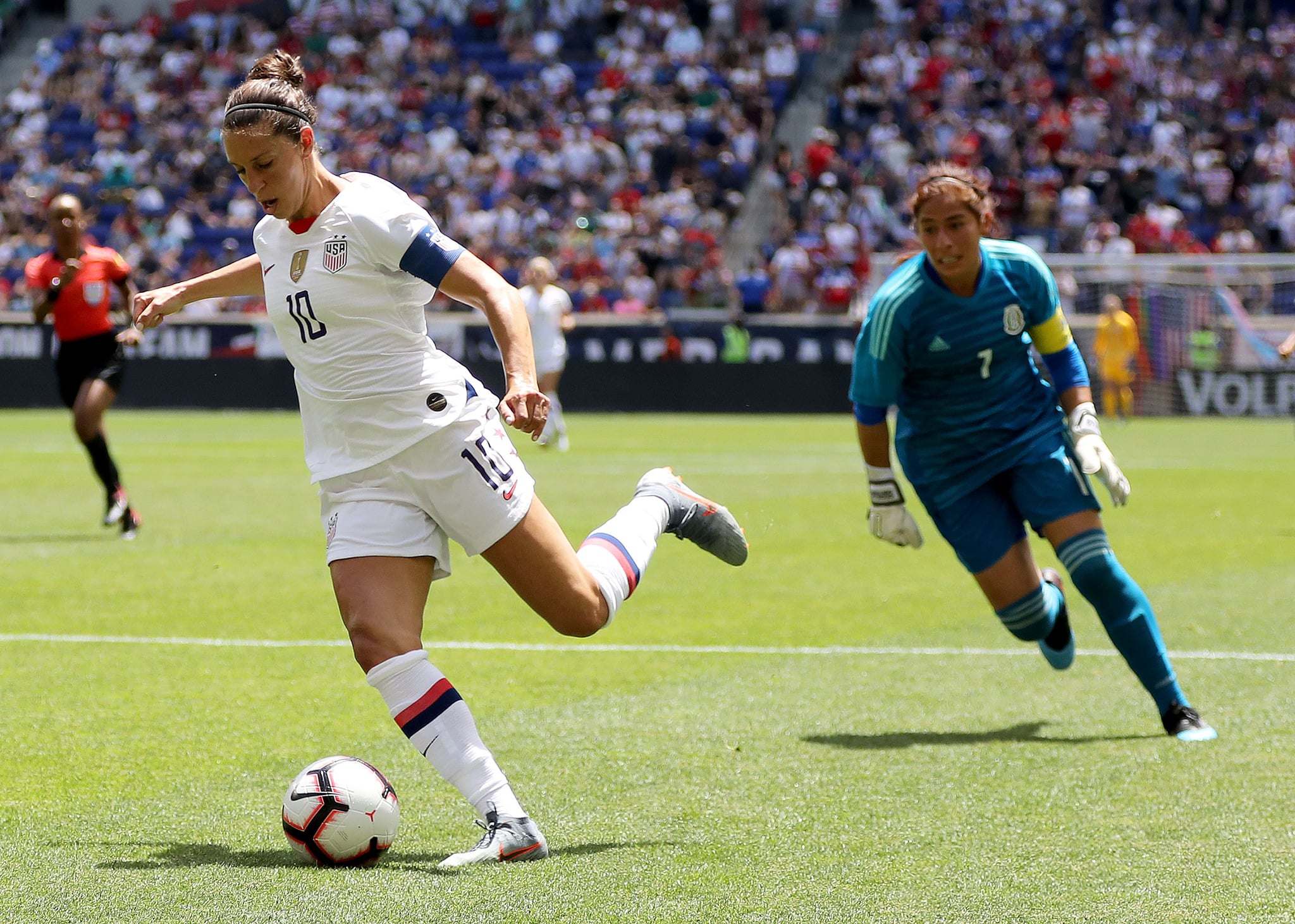 HARRISON, NEW JERSEY - MAY 26:  Carli Lloyd #10 of the United States catches Cecilia Santiago #1 of Mexico out of position in the second half at Red Bull Arena on May 26, 2019 in Harrison, New Jersey. (Photo by Elsa/Getty Images)