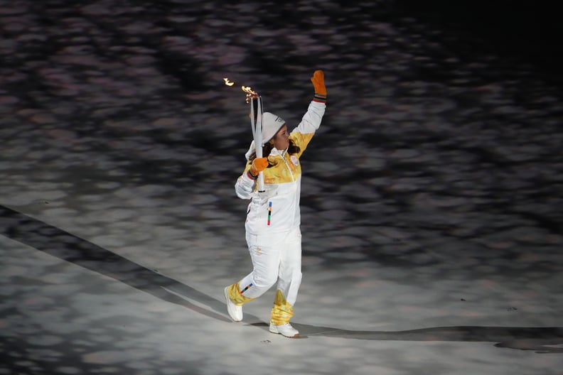 A torchbearer entered the stadium.