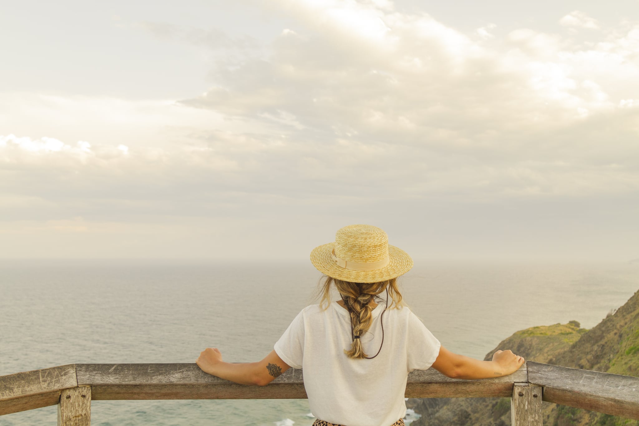 Young summer woman wearing hat and sunglasses at the beach