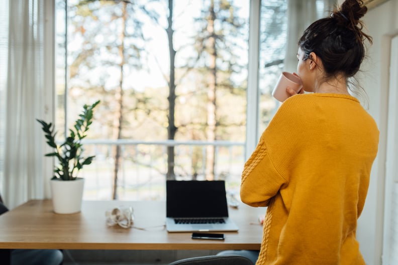 Young woman taking a break at her home office during the quarantine due to Covid-19.