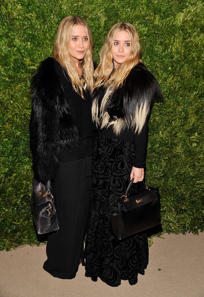 Twinning combo: Complementing furs and matching leather totes were the girls' look of choice for the CFDA/Vogue Fashion Fund Awards in 2003.

Mary-Kate fused fur, leather, and wool to create her monochromatic look.
Ashley layered a plush ombré topper over her jacquard maxi skirt.