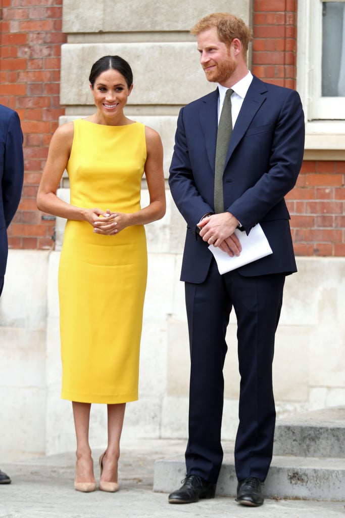 Prince Harry in a Navy Suit, and Meghan Markle in a Yellow Dress