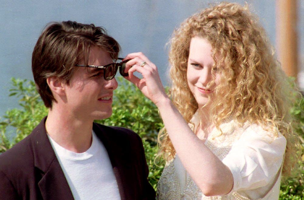 Nicole Kidman playfully adjusted then-husband Tom Cruise's sunglasses in 1992.