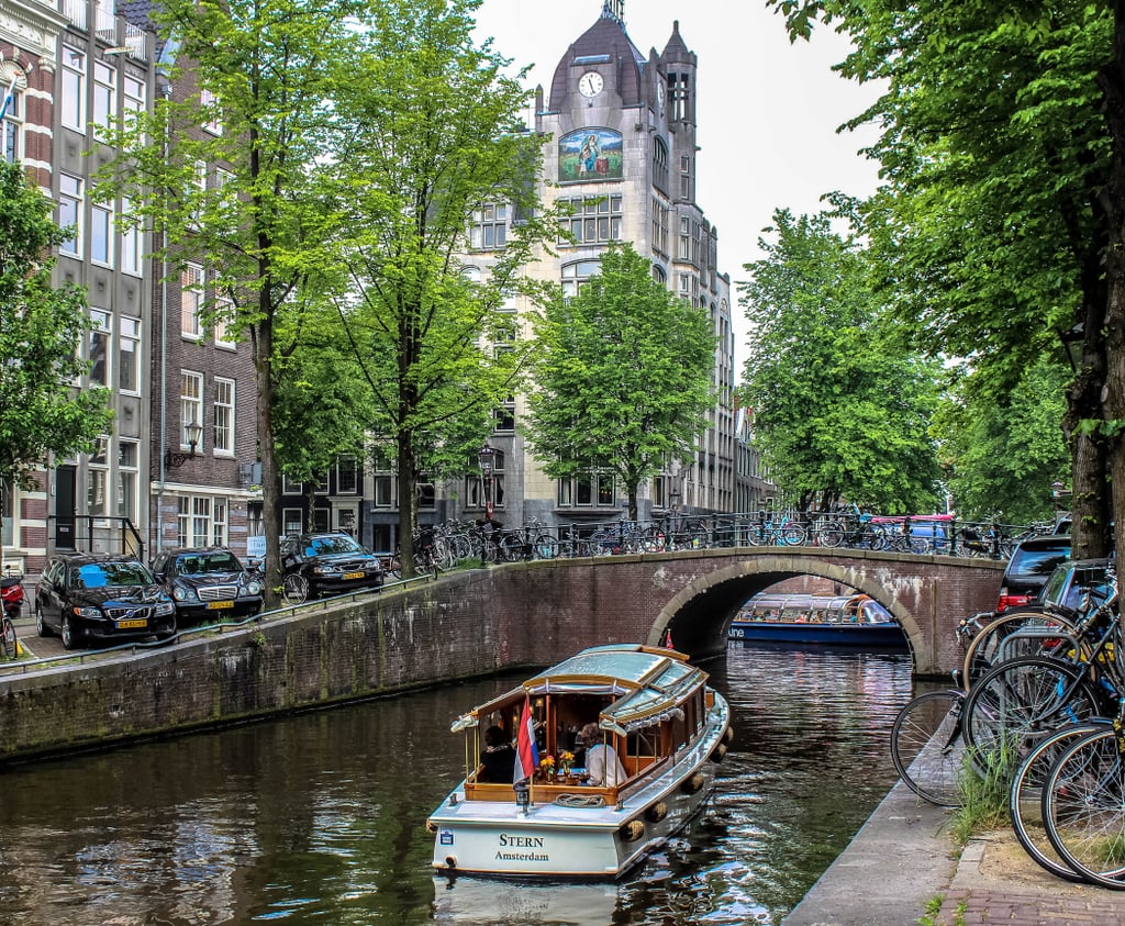 Because so much of Amsterdam's history is intimately intertwined with water, another fascinating way to get to know the city is by cruising along one of the 165 canals. If you're looking to join a canal-cruising tour, consider hopping aboard one of the boats provided by the budget-friendly Amsterdam Canal Cruises. No matter the time of day, this will be an unforgettable experience.