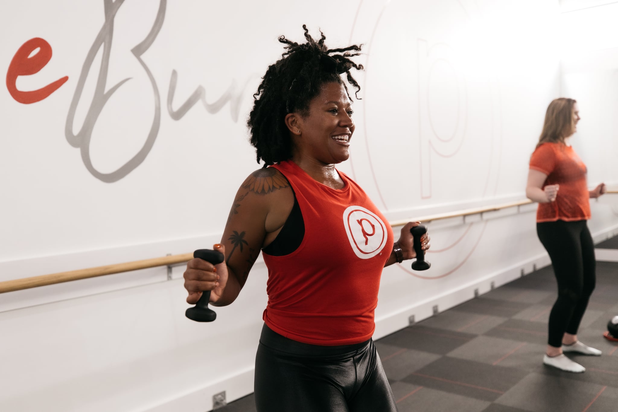 women holding weights during Pure Barre class: how much does Pure Barre cost?