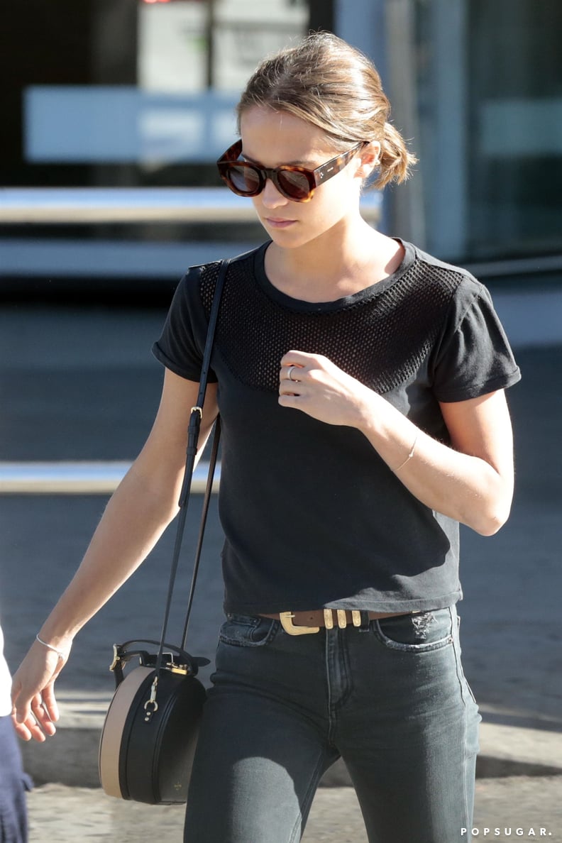 Keeping It Simple With a Black Tee, Dark Jeans, and a Round Bag