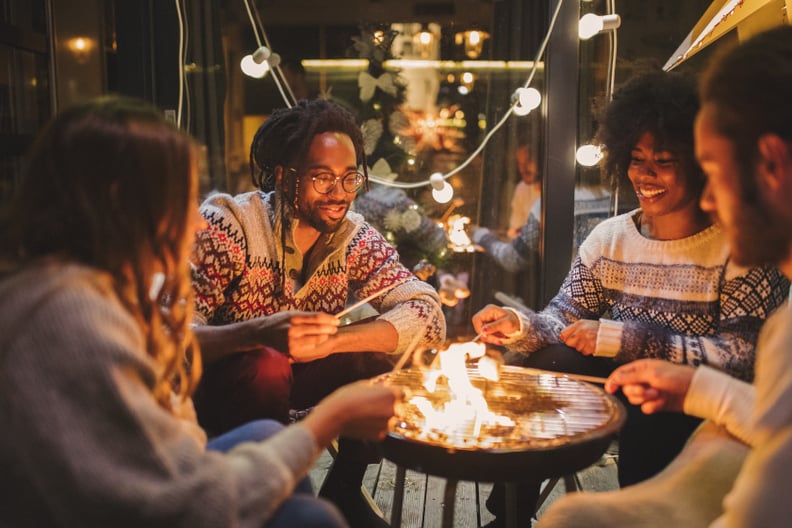 Friends on porch making roasted marshmallow