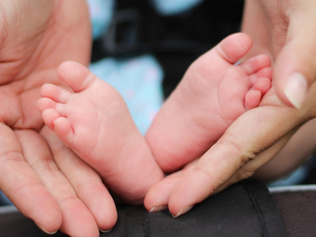 Hold a baby and check out those cute baby feet.