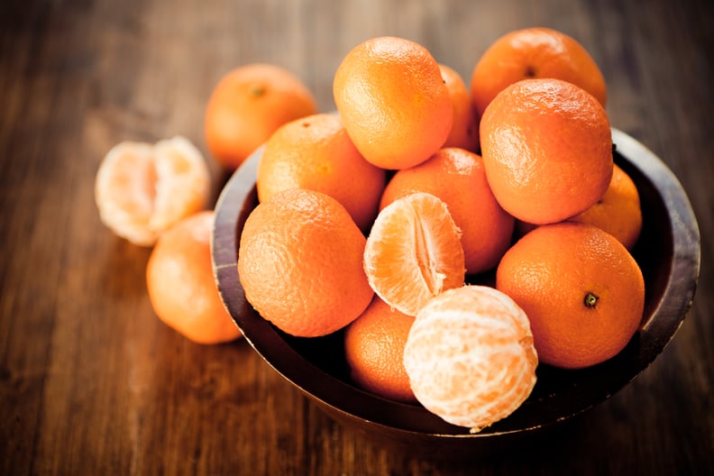 Citrus fruit: Clementines in a rustic wooden bowl.