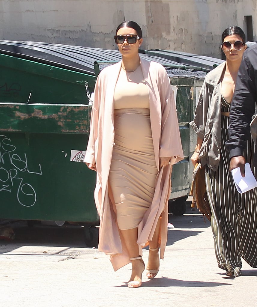 Kim covered her sand-colored midi with a dusty-pink jacket.