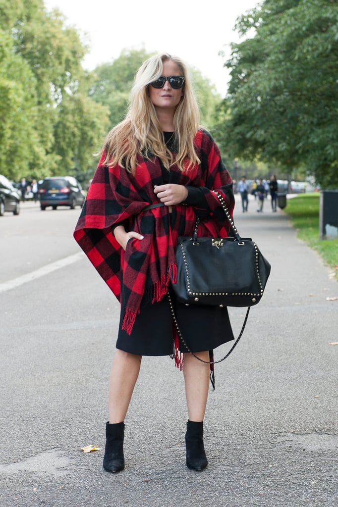 Keep the fact you're wearing a basic little black dress altogether hidden by belting a buffalo plaid poncho on top.