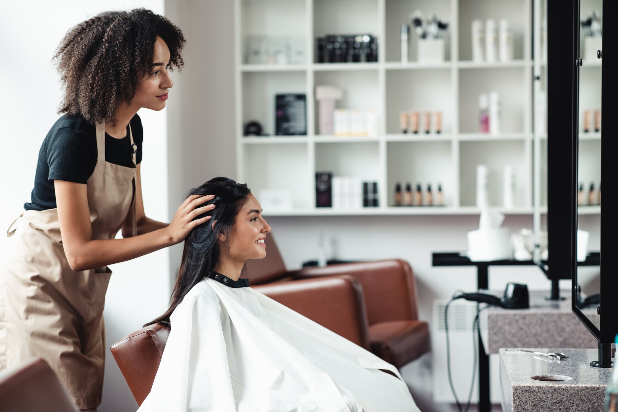 Young woman looking for changes, trying new hairstyle at beauty salon, empty space