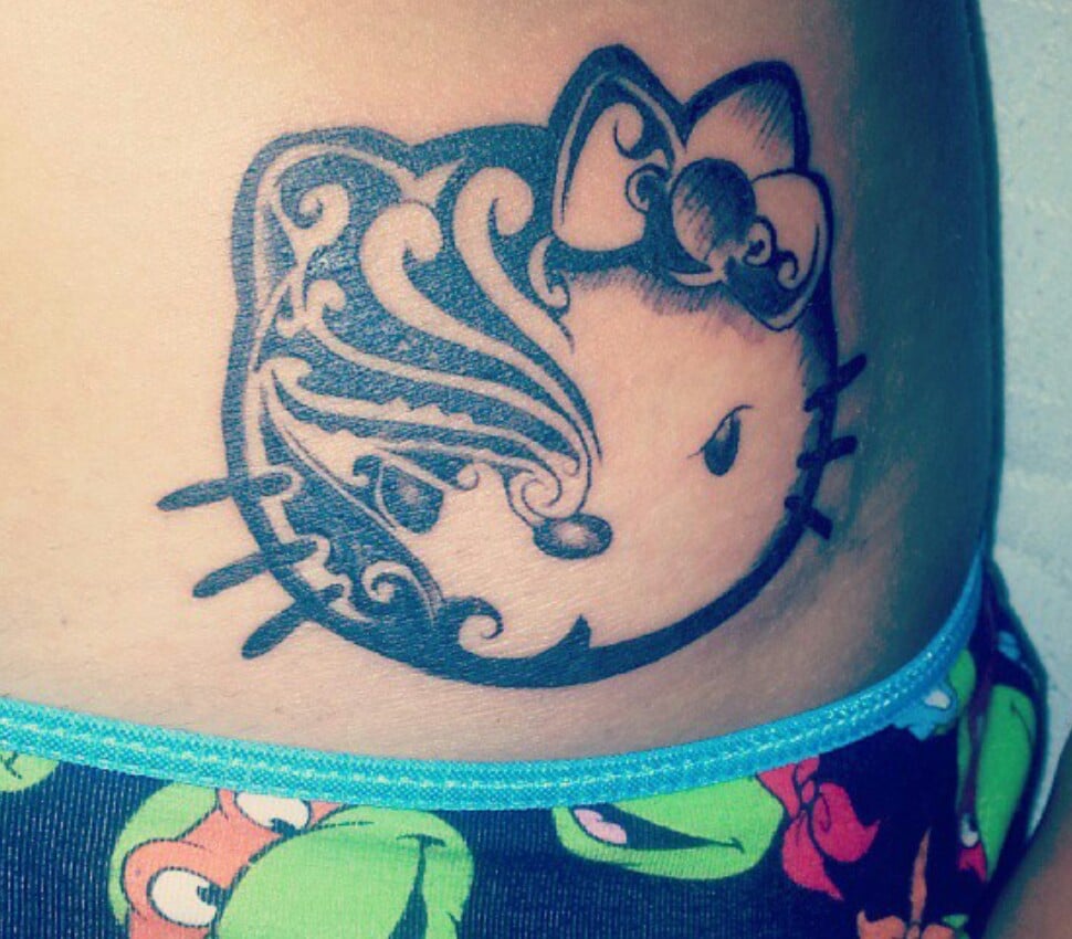 Minimalistic style Hello Kitty tattoo located on the