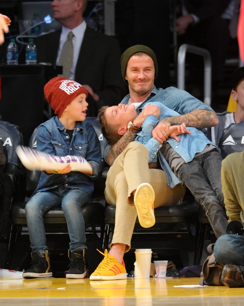 David Beckham clowned around courtside with his sons Cruz and Romeo during a Lakers game in November 2012.