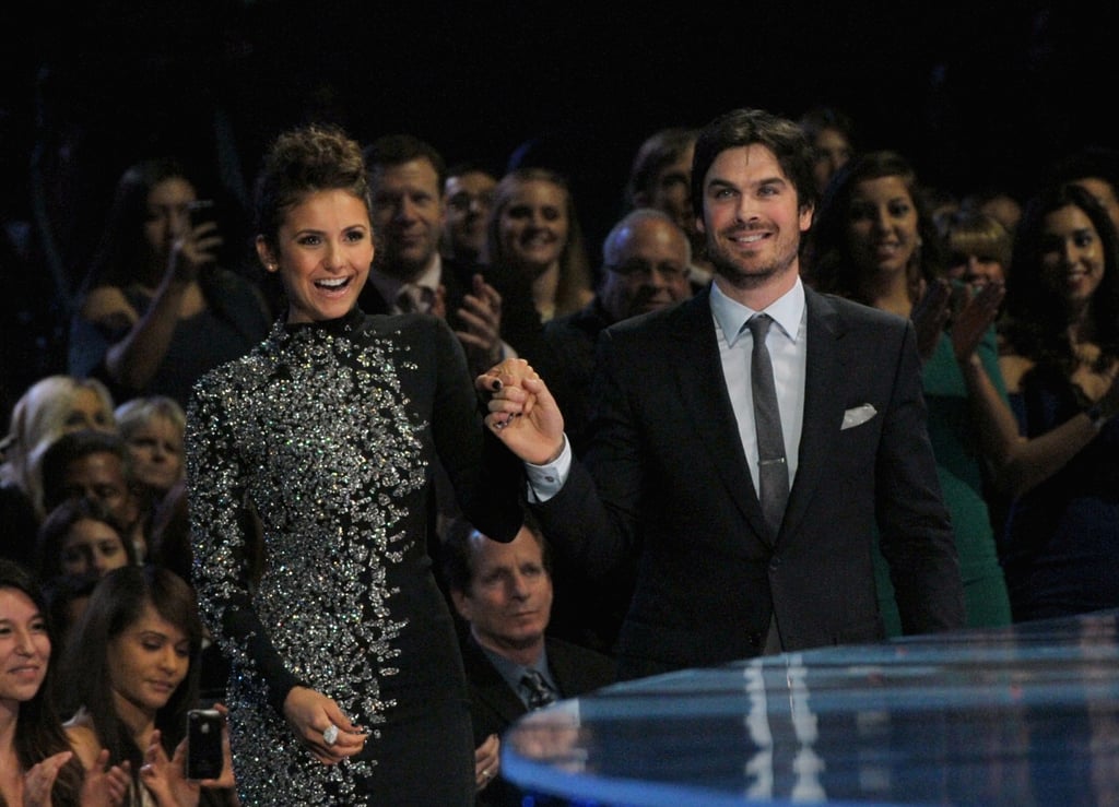 They walked hand in hand up to the stage.
