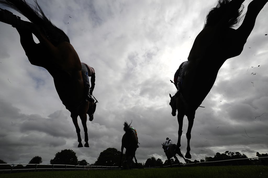 Racehorses jumped over a fence during a steeple chase in Fontwell, West Sussex, England, on Thursday.