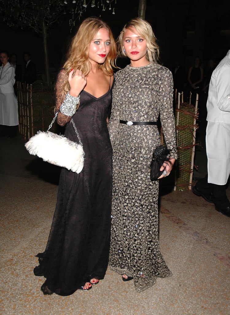 Twinning combo: The dynamic duo upped the glam factor with feathered bags and red-hot lipstick at the 2006 Met Gala.

Mary-Kate posed next to her partner in crime donning a slinky black gown by Badgley Mischka with lace sleeves and a white feathered bag.
Ashley polished off her beaded Badgley Mischka creation with a black feather clutch and diamond cluster earrings.