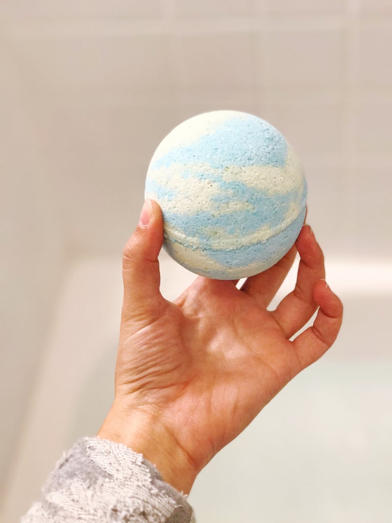 The bomb itself is shaped like the earth, with clouds of green and aqua blue.